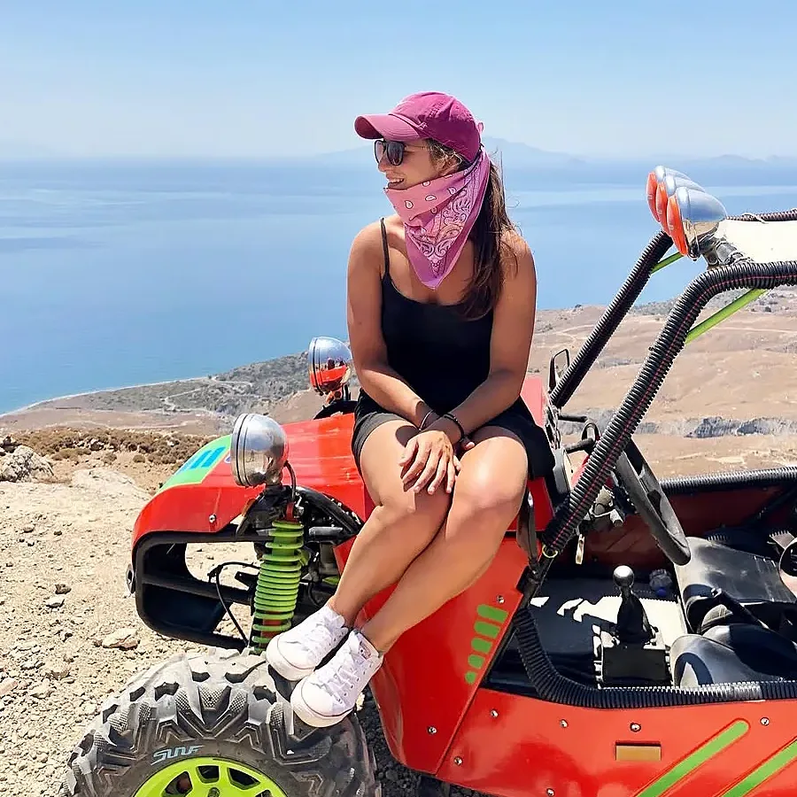 Woman sitting on a buggy with sea view during an off-road tour in Kos