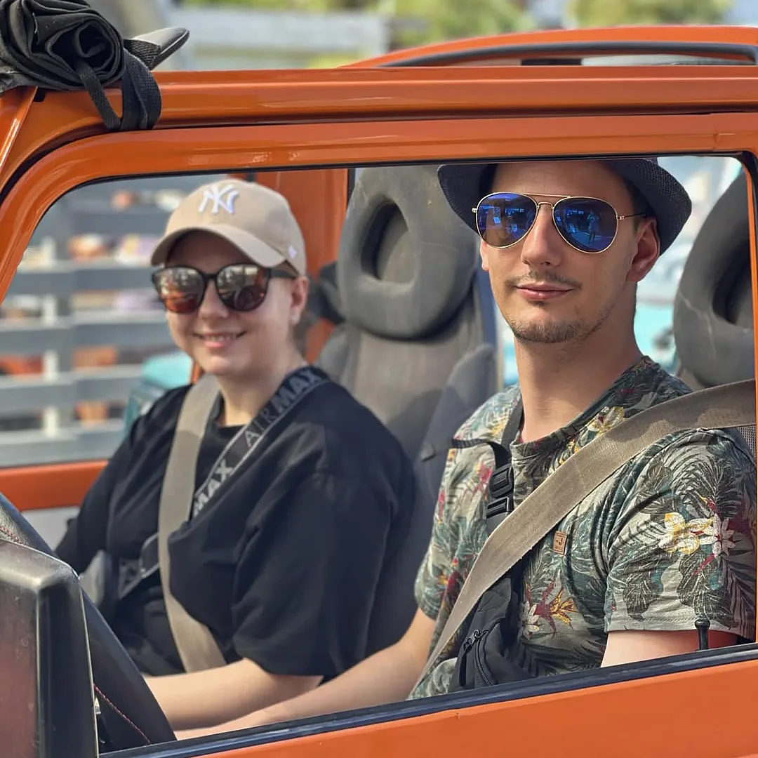 Couple driving an open buggy car during a rental experience in Kos, Greece