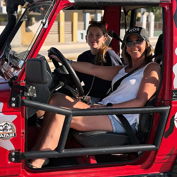 Mother and daughter driving a buggy car rental in Kos, Greece